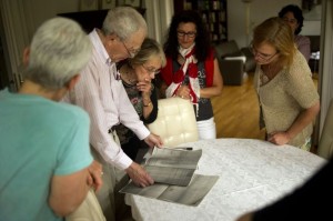 Edward Lowenstein looks at documents about his family presented to him by the owner of the first floor of his grandfather's former home in Essen, Germany. (Photo courtesy of Jon Lowenstein, NOOR)